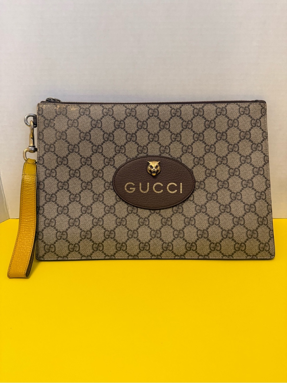 Gucci GG Supreme Canvas Wrist Pouch in Brown with Yellow Strap
